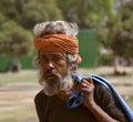 emphatic face of a gray-haired indian man