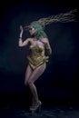 Empire, Latin woman with green hair and gold costume with handmade flourishes, fantasy image and tale