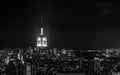 Sundown from the top of the rock - Empire State Building pinnacle brightly lit to the left of the frame - in black and white Royalty Free Stock Photo