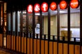 Employee of an Asian restaurant Din Tai Fung, making dumplings, viewed through the open kitchen in a shopping mall