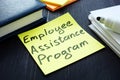 Employee assistance program EAP sign and pile of papers