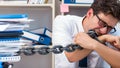 Employee attached and chained to his desk with chain Royalty Free Stock Photo