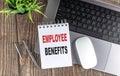 EMPLOYEE BENEFITS text on notebook with laptop, mouse and pen Royalty Free Stock Photo