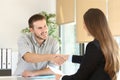 Employee and boss handshaking after a job interview