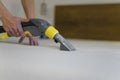 Employee of cleaning company cleans and disinfecting the mattress using a washing vacuum cleaner. Furniture dry cleaning process. Royalty Free Stock Photo