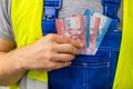 An employee counting his earnings, Chilean money, The concept of wages and labor costs in industry Royalty Free Stock Photo