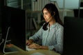 Service representative working as technical support call center in the office with headphone computer overtime Royalty Free Stock Photo