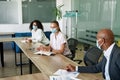 Employee discuss with colleague at meet in office Royalty Free Stock Photo