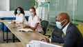 Employee discussing with her colleague at meeting Royalty Free Stock Photo