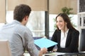 Employee giving folder to his manager during interview