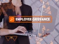 EMPLOYEE GRIEVANCE phrase on the screen. Manager use internet technologies at office. Concept search and EMPLOYEE GRIEVANCE