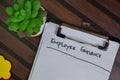 Employee Grievance write on a paperwork isolated on Wooden Table