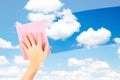 Employee hand cleaning a glass with rain drops and blue sky background Royalty Free Stock Photo