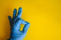 Employee hand in rubber glove with micro fiber cloth cleaning