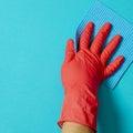 Employee hand in rubber protective glove with micro fiber cloth wiping wall from dust. Commercial cleaning company concept