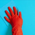 Employee hand in rubber protective glove with micro fiber cloth wiping wall from dust. Commercial cleaning company concept