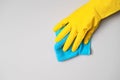 Employee hand in rubber protective glove with micro fiber cloth wiping wall from dust Royalty Free Stock Photo