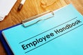 Employee handbook and clipboard on table Royalty Free Stock Photo