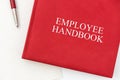 Employee Handbook or manual with a pen and paper on a white table in an office. Royalty Free Stock Photo