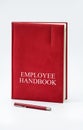 Employee Handbook or manual with a pen and paper on a white table in an office. Royalty Free Stock Photo