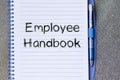 Employee handbook text concept on notebook Royalty Free Stock Photo