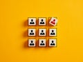 Employee icons on wooden cubes. Firing an employee from the team. Business layoff and downsizing