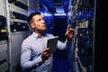 Employee inspecting hardware equipment in colocation center