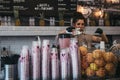 Employee making juice inside Joe & The Juice cafe in Richmond, London, UK. Royalty Free Stock Photo