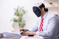 Male employee with mask in hipocrisy concept Royalty Free Stock Photo