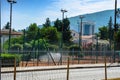 The employee moistens the tennis court with water from the hose Royalty Free Stock Photo