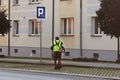 An employee of the municipal service of the city removes the territory. Refinement of the area around the house. Mowing of grass b