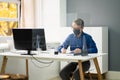 Employee In Office Social Distancing Using Sneeze Guard