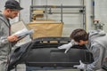 An employee of the paint shop of the automobile plant conducts training on the preparation of bumpers for painting