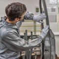 An employee of the quality Department of the car body paint shop checks the quality of applying the sealant