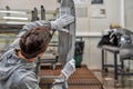 An employee of the quality Department of the car body paint shop checks the quality of applying the sealant