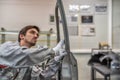 An employee of the quality Department of the car body paint shop checks the quality of applying the sealant