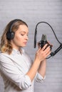 An employee of a radio station, works on the radio, or on the sound recording of film dubbing. Vertical photo