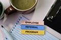 Employee Referral Program text on sticky notes with office desk concept