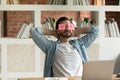 Employee relaxing at workplace with sticky notes on his eyes Royalty Free Stock Photo