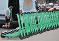 An employee of the rental service unloads electric scooters on the sidewalk in the city center