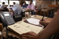 Employee at a restaurant writing down a table reservation Royalty Free Stock Photo