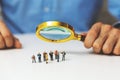 Employee search staff selection concept - recruitment manager with magnifying glass