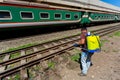 An employee sprays disinfectant on a outside of train as a precaution against a new at Royalty Free Stock Photo