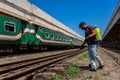 An employee sprays disinfectant on a outside of train as a precaution against a new coronavirus at Royalty Free Stock Photo