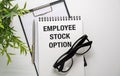 Employee Stock Option write on sticky notes isolated on White Table. Business Concept. Royalty Free Stock Photo