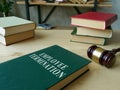 Employee termination rules book and wooden gavel.