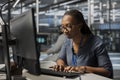 Employee using PC to oversee data center equipment Royalty Free Stock Photo