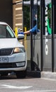 An employee wearing protective gloves passes the order to the car driver through a secure window in a fast food restaurant