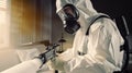 An employee wearing a protective suit decontaminates the room. Royalty Free Stock Photo