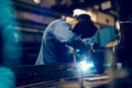 Employee welding steel with sparks using mig mag welder Royalty Free Stock Photo